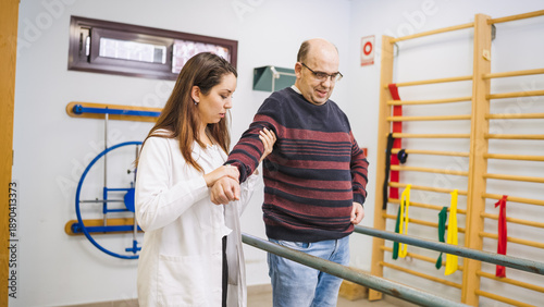 Konstfotografi Physiotherapist aiding a male patient with a long term physical condition, empha