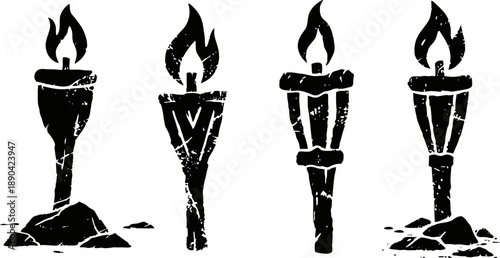 Four vintage burning torches with flames standing on rocky ground silhouette set