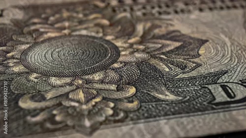 A detailed close-up shot of an intricate pattern on a piece of currency, highlighting security features and artistry.