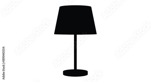 A simple black lamp stands on a white surface a striking silhouette