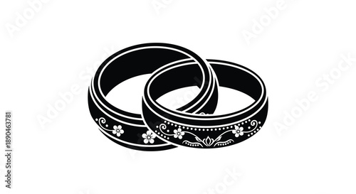 Two intertwined wedding rings displaying floral details are depicted in a striking black silhouette high quality professional detailed modern elegant stylish