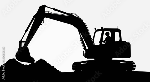 Silhouette of an excavator digging a pile of dirt.