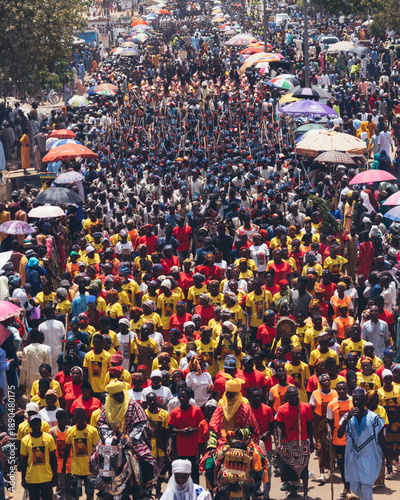 Wallpaper Mural Bauchi, Nigeria - 31 March 2025: View of a vibrant procession through the city, a sea of colorful attires under the sun, with figures on horseback amidst the bustling crowd. Torontodigital.ca