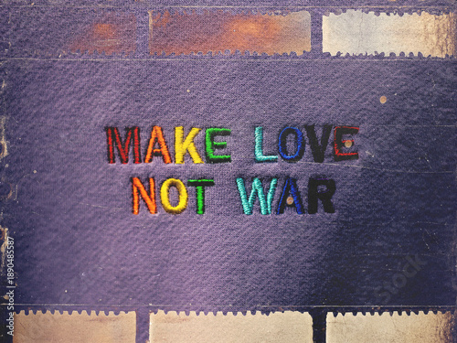 Canvastavla 'Make Love Not War' colorful embroidery on denim purple texture with vintage film frame