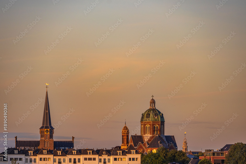 Fototapeta premium view of the village of Hoorn with church at sunset 