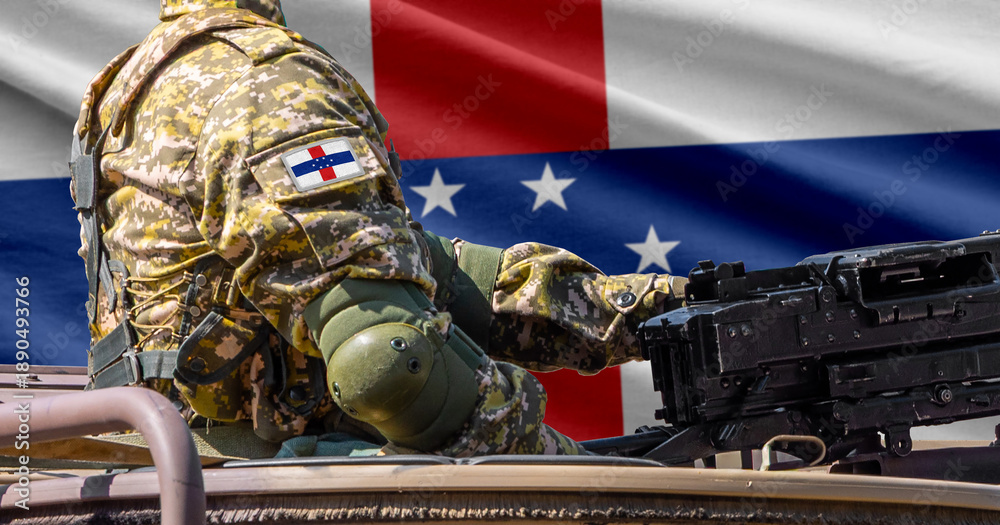 Fototapeta premium Netherlands Antilles flag with soldier at machine gun turret in front of it. Closeup side view.
