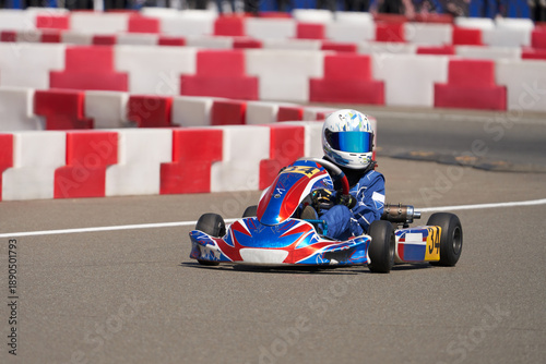 Εκτύπωση καμβά A child in a small-displacement racing car on a track with turns