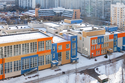 Modern colorful school complex in winter cityscape