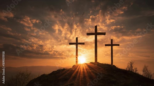 Three wooden crosses stand silhouetted against a dramatic sunset sky on a hilltop