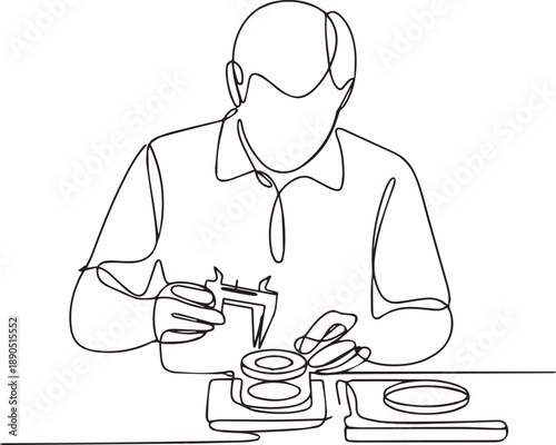Man working on watch with tools at a table viewed from above