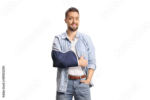 Tableau sur toile Cheerful young man with a broken arm wearing an arm sling