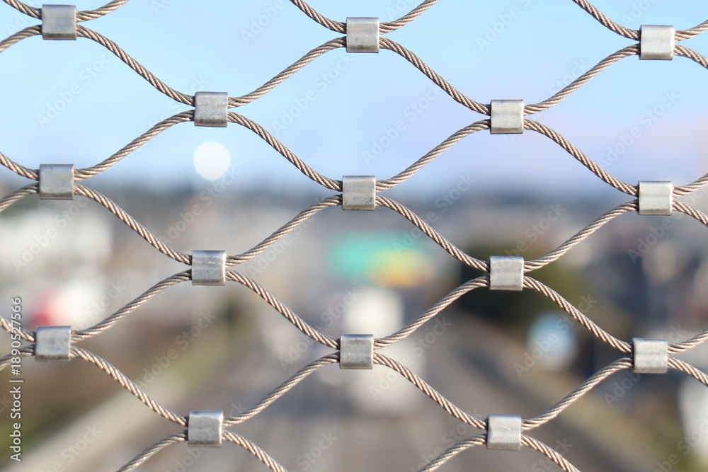 Fototapeta premium Traffic Seen Through Chain-Link Fence (Shallow Depth of Field)