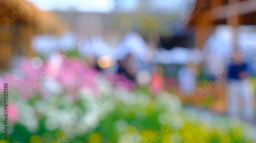 Wallpaper Mural A blurry image of a garden with people walking around. The flowers are pink and white, and the people are scattered throughout the scene. Scene is peaceful and serene, as the garden is a beautiful Torontodigital.ca