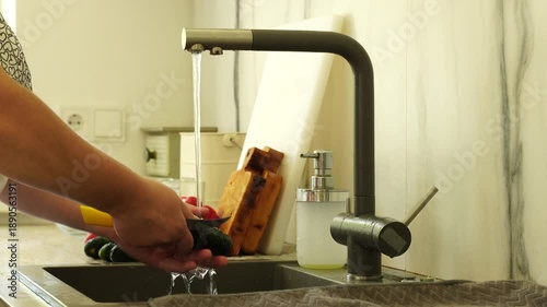 Woman washing vegetables before cooking
