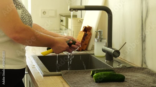 Woman washing vegetables before cooking
