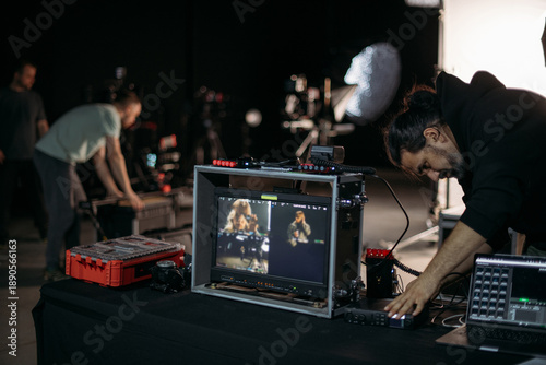 Film set, monitors and modern shooting equipment. Filming crew, lighting devices, monitoring, playback - filming equipment and a team of professionals in filming movies, ads and TV series.