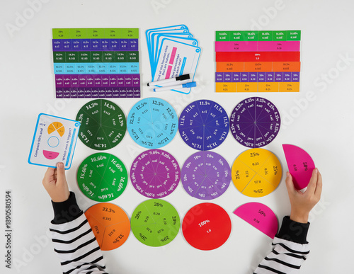 Принти на полотні A creative flat lay showing a student solving mathematical problems using bright fraction manipulatives