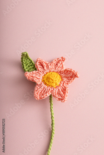 Single pink crochet flower handmade craft.