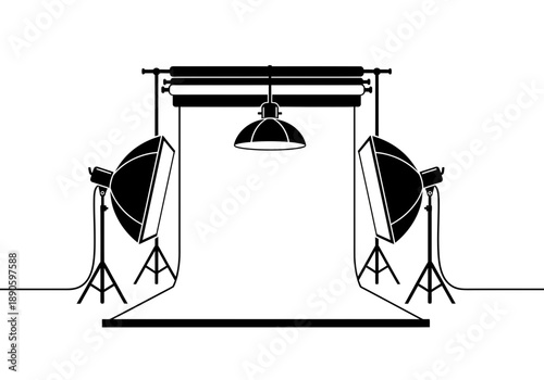 A professional photography studio setup with softbox lights and a backdrop.