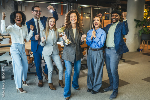 Fotografie Diverse business team celebrating success winning an award trophy
