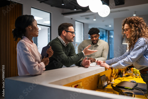 Valokuva Diverse business team collaborating at office reception desk