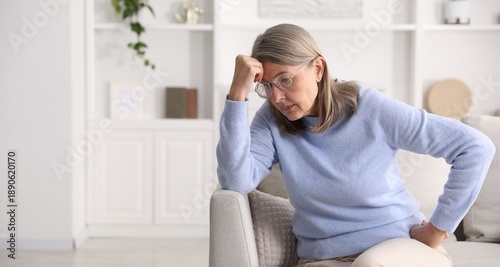 Amnesia. Senior woman trying to remember something at home, space for text