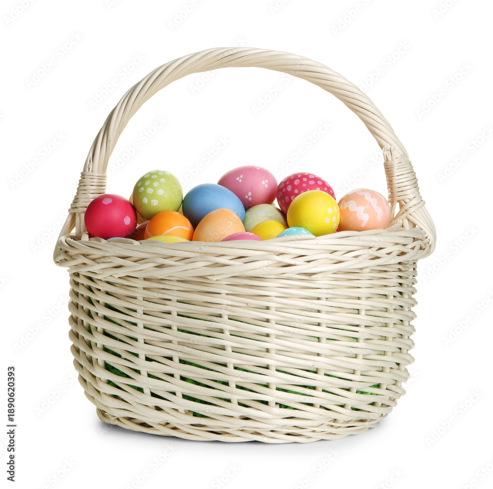 Fototapeta premium Painted Easter eggs in wicker basket isolated on white