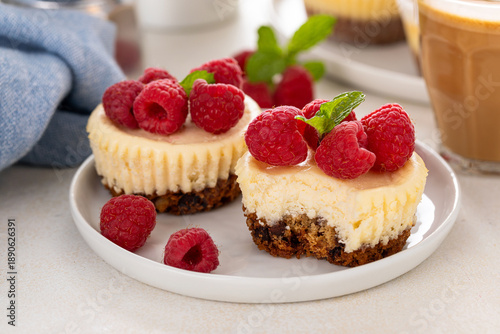 Quadro em tela Mini cheesecakes topped with fresh raspberries on a serving plate