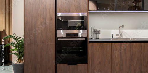 Quadro su tela Built-in oven and microwave in modern dark wood kitchen