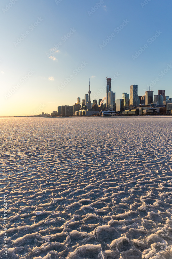 Fototapeta premium Pancake ice in Lake Ontario with the Toronto skyline in the background - Polar vortex arctic air over the city