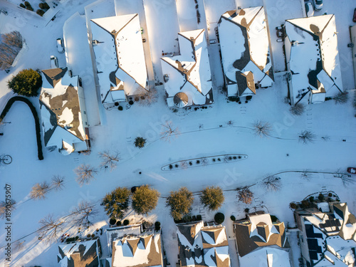 Fotografi Drone aerial view of residential suburb with single-family homes covered in fresh snow on roofs, yards and streets under clear winter sky