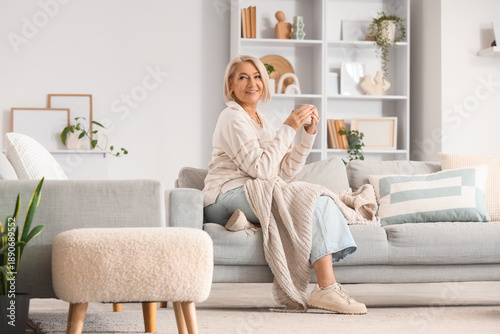 Mature woman with cup of te...