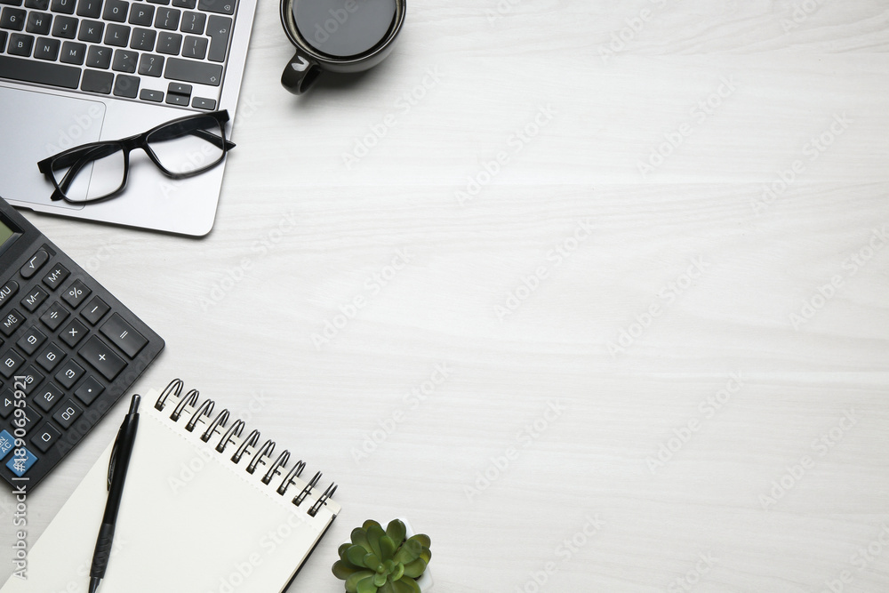 Fototapeta premium Office workplace. Laptop, coffee and stationery on white wooden desk, flat lay. Space for text