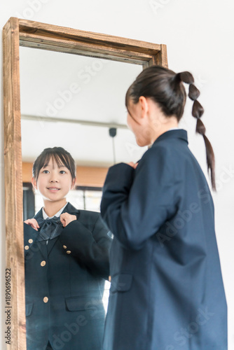 Bild auf Leinwand Girls in elementary, junior high, and high school uniforms getting ready in the