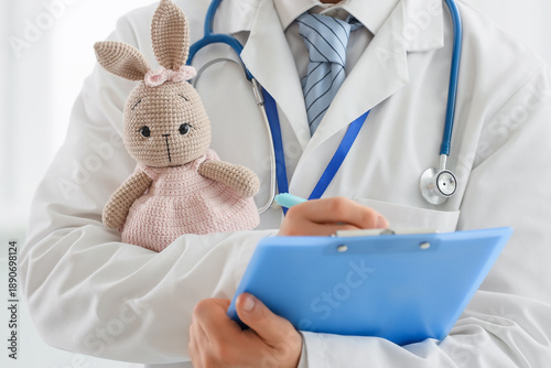Male pediatrician with toy ...