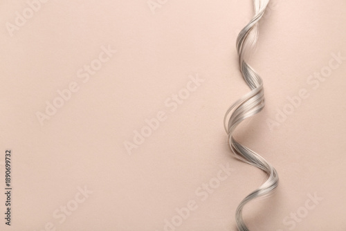 Curly grey hair strand on b...