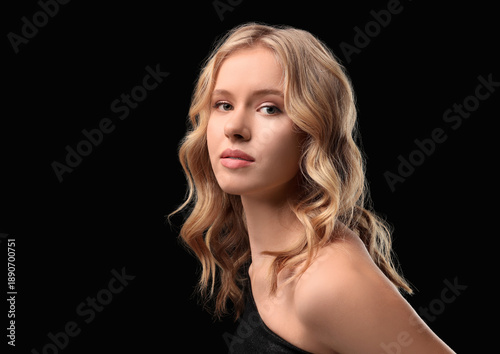 Blonde young woman with cur...