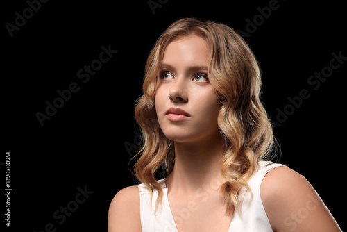 Blonde young woman with cur...