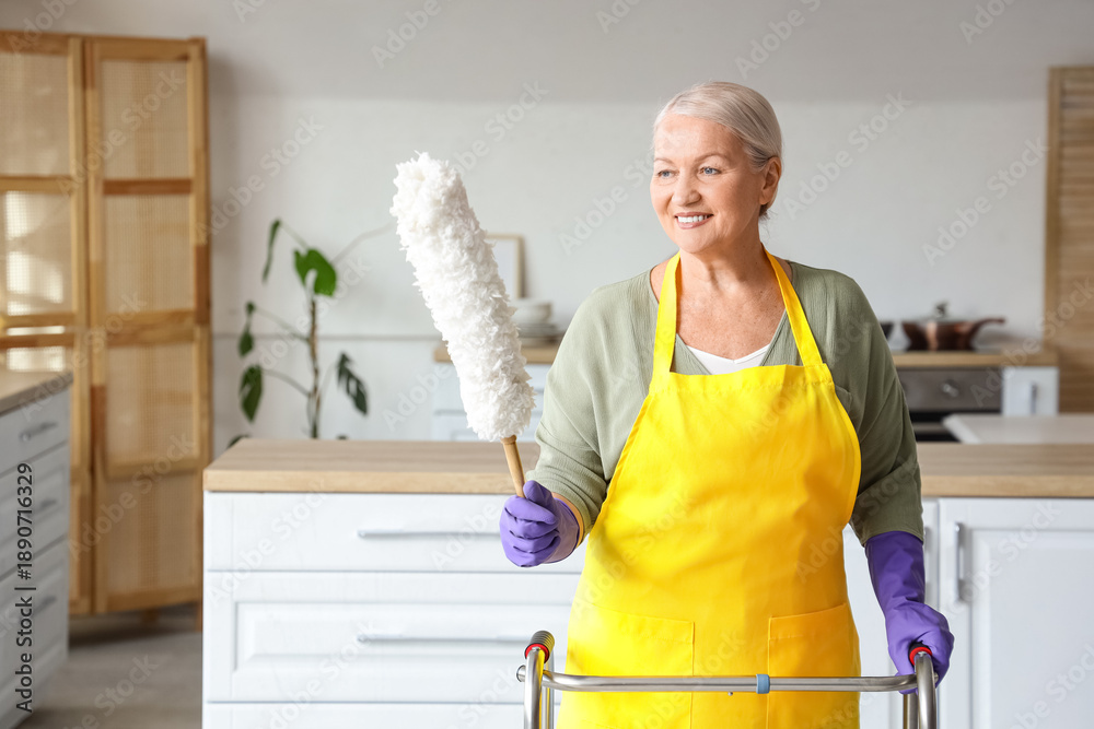 © Pixel-Shot - Mature woman with walker and pp-duster in kitchen
