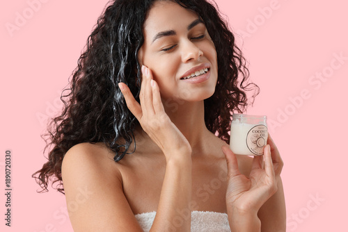 Young woman applying coconu...