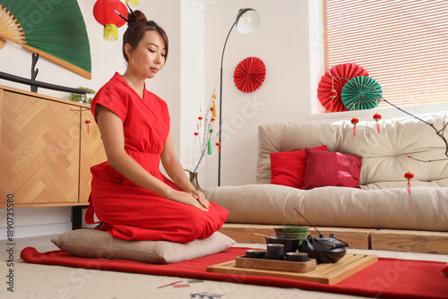 Young Asian woman with tea ...
