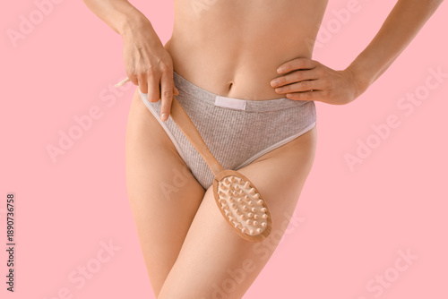 Young woman massaging her l...