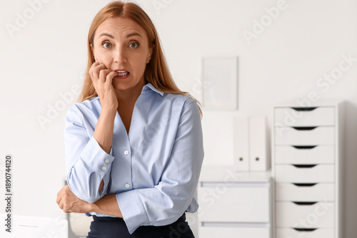 Worried mature businesswoma...