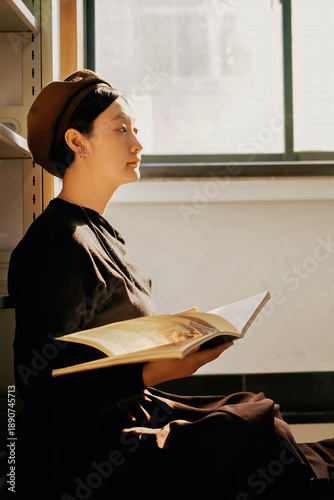 Young woman reading book in vintage styled interior