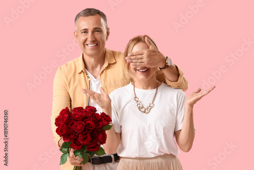 Happy mature man with bouqu...