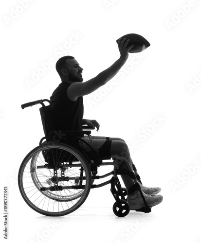 Silhouette of sporty young man in wheelchair with rugby ball on white background