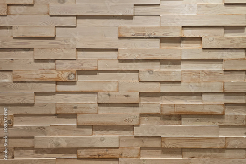Full frame view of layered wooden wall panels arranged in a staggered geometric pattern, showcasing natural wood grain, texture and modern interior design background with copy space.