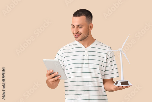 Young man with wind turbine...