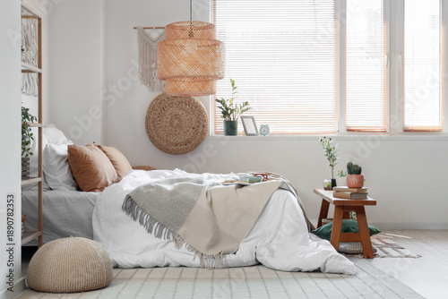 Vászonkép Big comfortable bed with breakfast, bench and houseplants in interior of bedroom