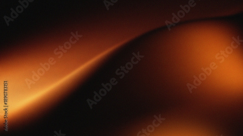 Orange, brown, and black colors that resemble folds of fabric or sand dunes in low light. The texture appears grainy, giving it a cinematic or artistic feel.